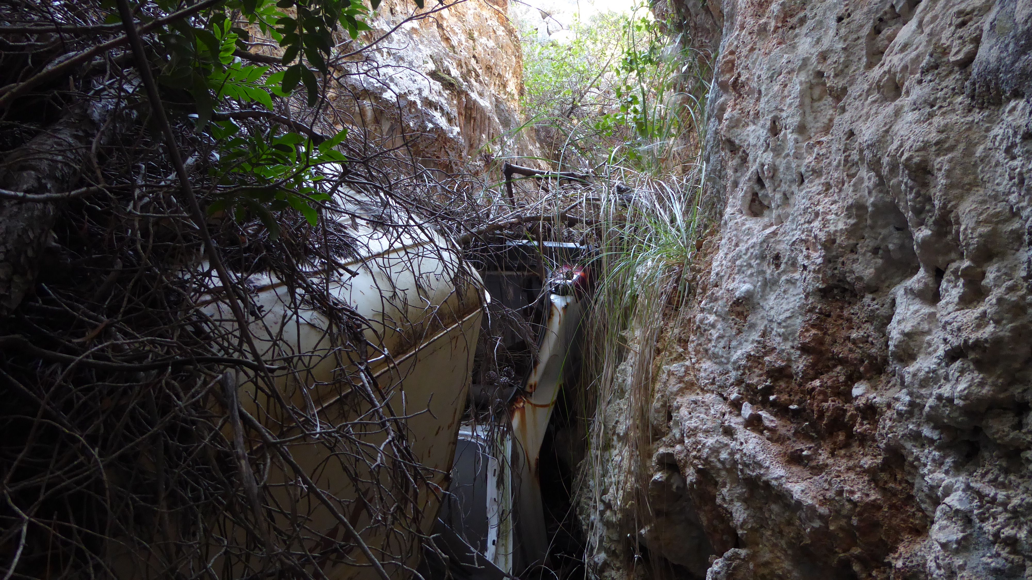 A disposed car in a trench.